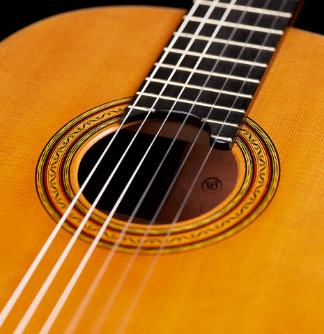 The top and rosette of a 2024 Vladimir Druzhinin classical guitar made with cedar and African rosewood.