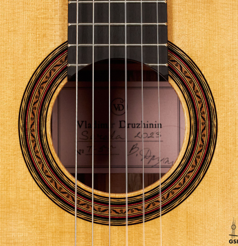 The rosette of a 2023 Vladimir Druzhinin classical guitar made with spruce and African rosewood.