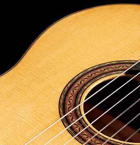 The soundboard of a 2023 Vladimir Druzhinin classical guitar made with spruce and African rosewood.