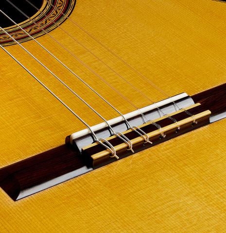 The bridge, tie-block and saddle of a 2025 Vladimir Druzhinin classical guitar made of spruce and African rosewood