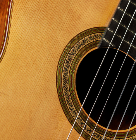 The soundboard and rosette of a 1981 Jeffrey Elliott classical guitar made of spruce and CSA rosewood