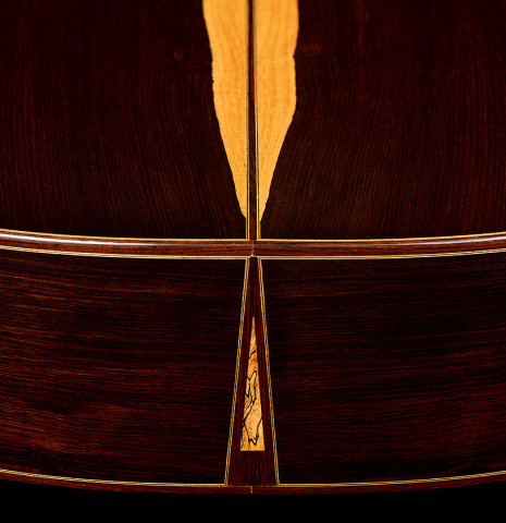 The back and sides at the foot of a 1990 Jeffrey Elliott classical guitar made of spruce and African blackwood