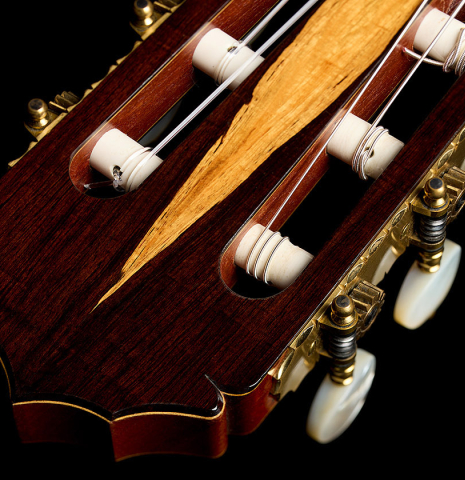 The headstock veneer and Rodgers tuners of a 1990 Jeffrey Elliott classical guitar made of spruce and African blackwood