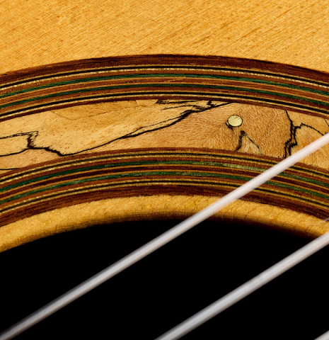 Closeup detail of the spalted maple rosette of a 1990 Jeffrey Elliott classical guitar made of spruce and African blackwood
