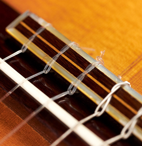 The bridge and saddle of a 1929 Domingo Esteso classical guitar made with spruce and cypress