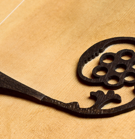 The ornate bridge inlay of a 2007 Lucian Faria "Baroque Guitar" made of spruce and CSA rosewood