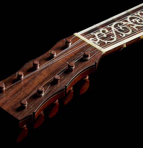 The pegged headstock and inlaid fingerboard of a 2007 Lucian Faria "Baroque Guitar" made of spruce and CSA rosewood