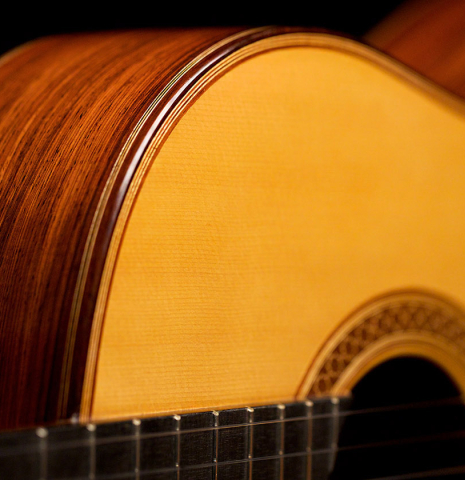 The soundboard and side of a 2022 Juan Garcia Fernandez classical guitar made with spruce top and cocobolo back and sides