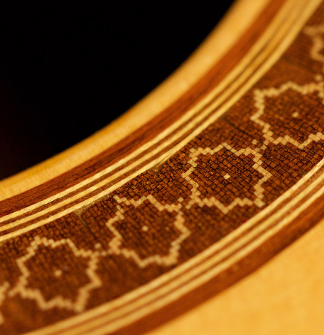 A close-up of the rosette of a 2022 Juan Garcia Fernandez classical guitar made with spruce top and cocobolo back and sides