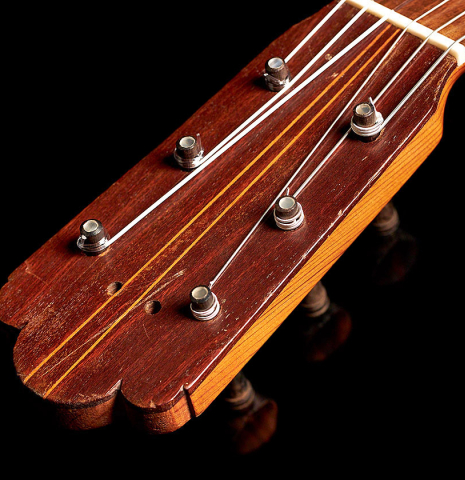 The headstock and traditional pegs of a 1891 Benito Ferrer historical classical guitar