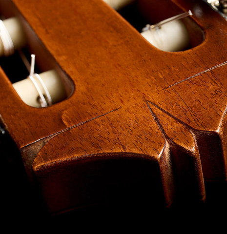 The carved headstock design of a 1966 Arcangel Fernandez classical guitar made of spruce and CSA rosewood