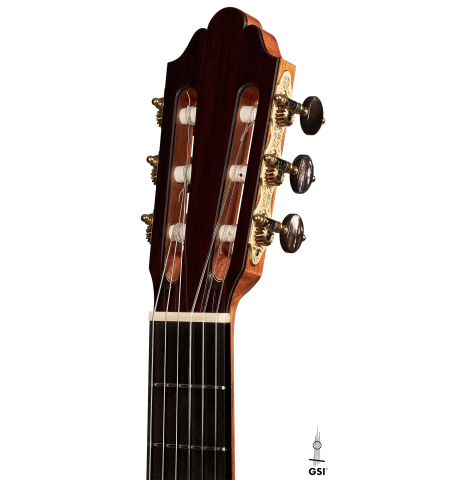 The headstock of a 2023 Dominique Field classical guitar made with spruce and CSA rosewood on a white background