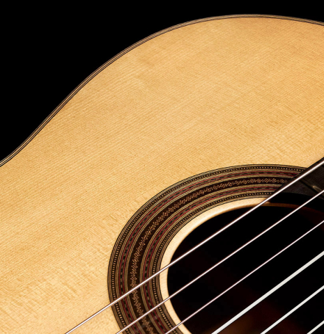 The soundboard and rosette of a 2023 Dominique Field classical guitar made with spruce and CSA rosewood