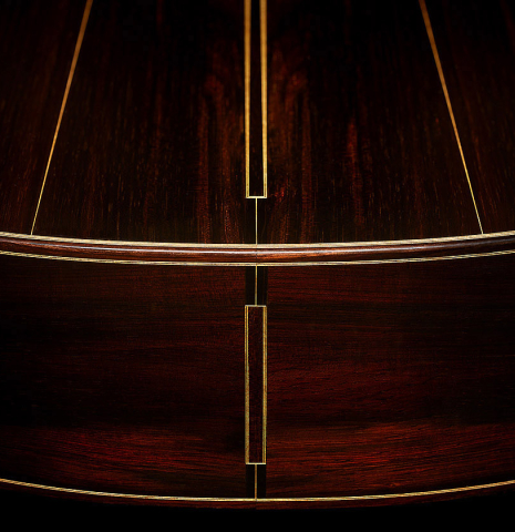 The back and sides at the foot of a 2025 Dominique Field classical guitar made of spruce and CSA rosewood