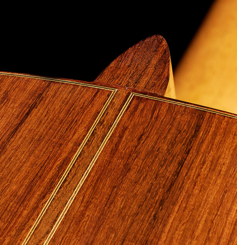 The heel and back center seam of a 1992 Dominique Field classical guitar made of spruce and Indian rosewood