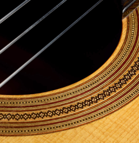 Detailed close-up of the rosette of a 1992 Dominique Field classical guitar made of spruce and Indian rosewood