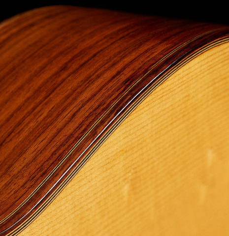 The top binding and purfling of a 1992 Dominique Field classical guitar made of spruce and Indian rosewood