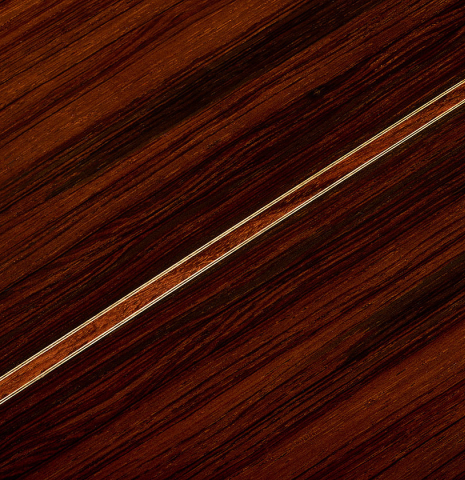 The back center seam of a 2011 Dominique Field classical guitar made of spruce and CSA rosewood