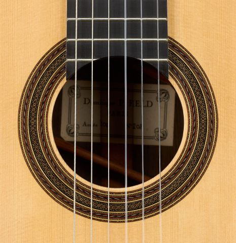 The rosette of a 2011 Dominique Field classical guitar made of spruce and CSA rosewood