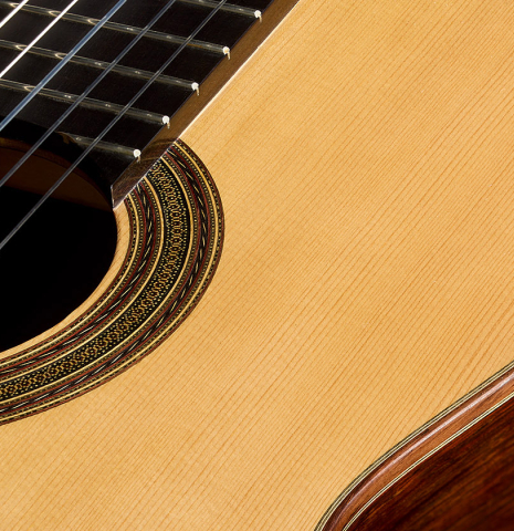 The soundboard and rosette of a 2011 Dominique Field classical guitar made of spruce and CSA rosewood