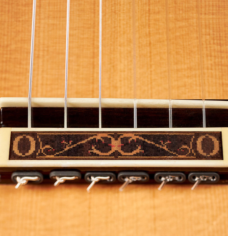 The bridge of a 2007 Paul Fischer "Premier Taut" classical guitar made with spruce and CSA rosewood.