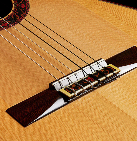 The bridge, tie-block and saddle of a 1990 Paul Fischer "Virtuoso" classical guitar made of spruce and CSA rosewood