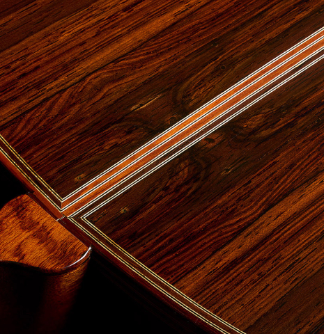 The heel, back binding and purfling of a 2008 Paul Fischer "Premier" classical guitar made of cedar and CSA rosewood
