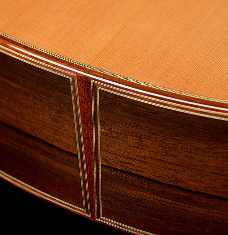 The foot with bindings and purflings of a 2008 Paul Fischer "Premier" classical guitar made of cedar and CSA rosewood