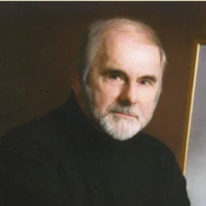 Portrait of Paul Fischer with a white beard, wearing a black turtleneck