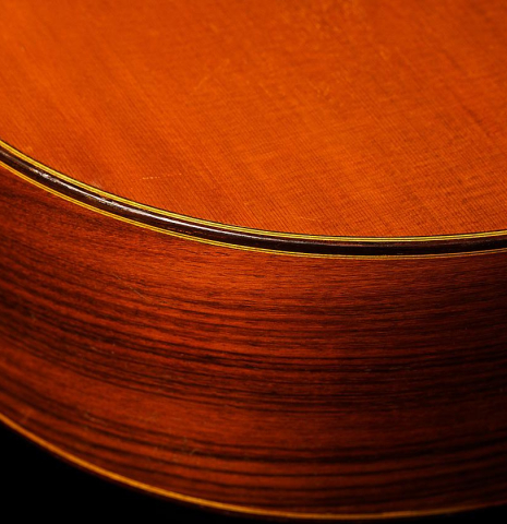 The side and binding of a 1968 Ignacio Fleta classical guitar made of cedar and Indian rosewood