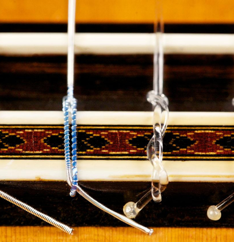 The bridge, tie-block and saddle of a 1969 Daniel Friederich classical guitar made of spruce and CSA rosewood