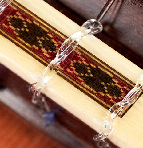 The tieblock of a 1994 Daniel Friederich classical guitar made of cedar and Indian rosewood.