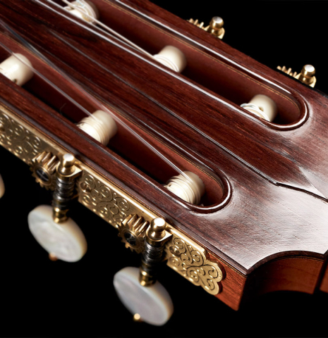 The headstock of a 1994 Daniel Friederich classical guitar made of cedar and Indian rosewood.