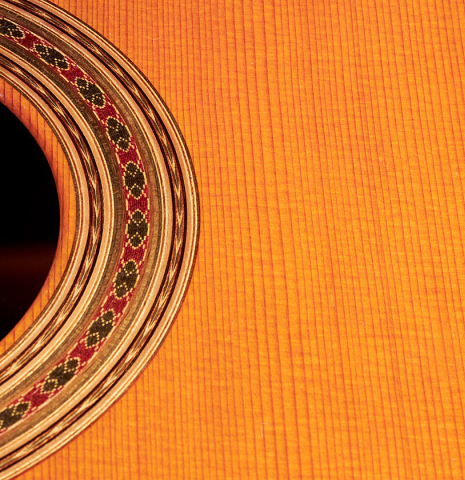 The soundboard and rosette of a 1994 Daniel Friederich classical guitar made of cedar and Indian rosewood.