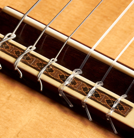 The bridge and tie block of a 1964 Daniel Friederich "Recital" classical guitar made with spruce and CSA rosewood.