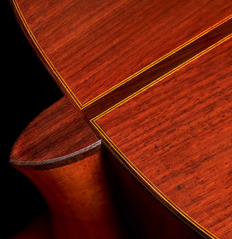 The heel and back center seam of a 1984 Daniel Friederich classical guitar made of cedar and Indian rosewood.