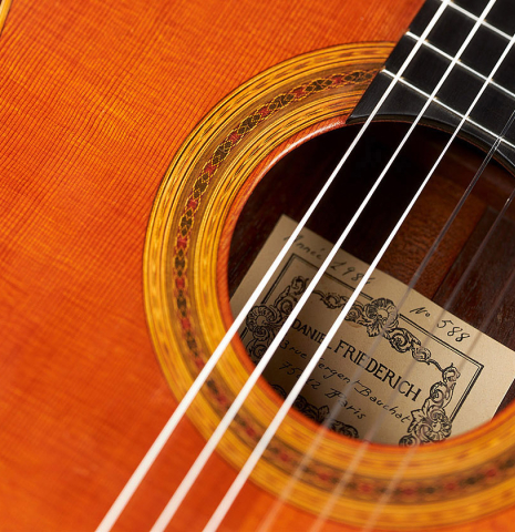 Detailed closeup of the rosette of a 1984 Daniel Friederich classical guitar made of cedar and Indian rosewood.