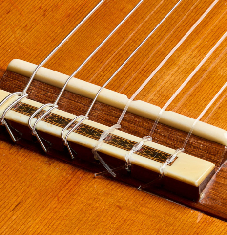 The bridge, tie-block and saddle of a 1988 Daniel Friederich (ex Roberto Aussel) classical guitar made of cedar and Indian rosewood.
