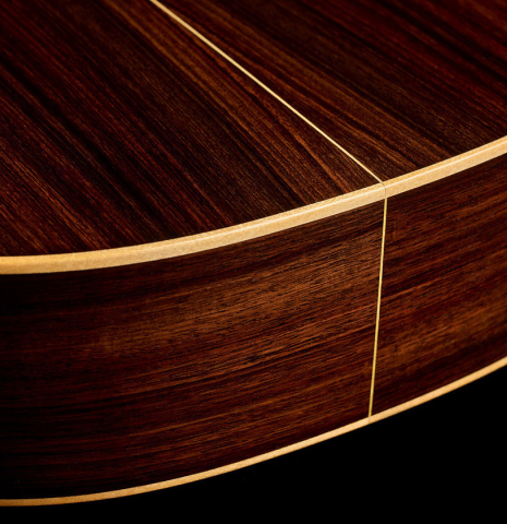 The back and sides at the foot of a 2025 Liuteria Frignani "1910 Manuel Ramirez" classical guitar made of spruce and Indian rosewood