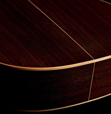 The back and sides at the foot of a 2026 Liuteria Frignani "1910 Manuel Ramirez" classical guitar made of spruce and Indian rosewood