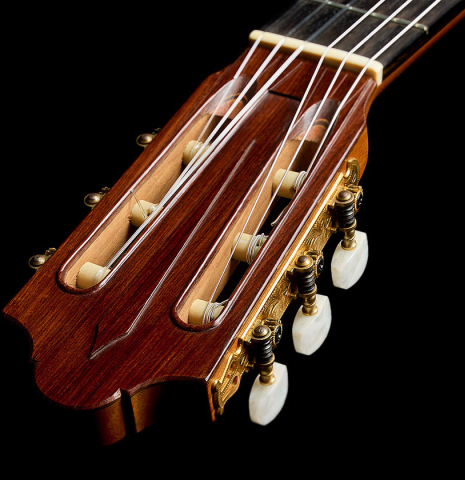 The carved headstock of a 1975 Daniel Friederich classical guitar made of cedar and Indian rosewood