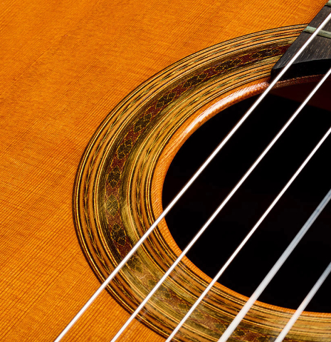 The soundboard and rosette of a 1975 Daniel Friederich classical guitar made of cedar and Indian rosewood
