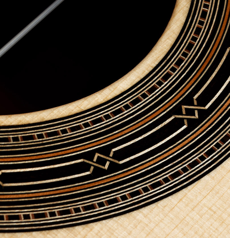 Detailed close-up of the rosette of a 2024 Hironori Fukuda classical guitar made of spruce and African rosewood