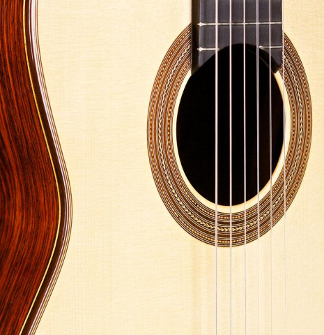 The soundboard and rosette of a 2014 Francisco Navarro Garcia "Hauser" classical guitar made with spruce and cocobolo