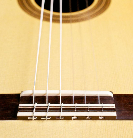 The bridge and saddle of a 2014 Francisco Navarro Garcia "Hauser" classical guitar
