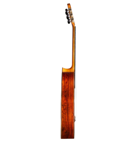 The side of a 2014 Francisco Navarro Garcia &quot;Hauser&quot; classical guitar made with spruce and cocobolo on a white background