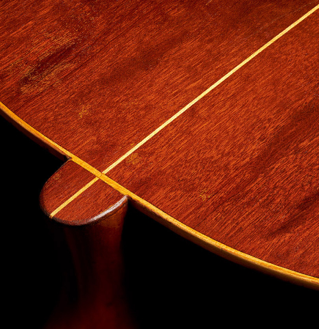 The heel and back bindings/purflings of a 1903 Enrique Garcia classical guitar made of spruce and mahogany