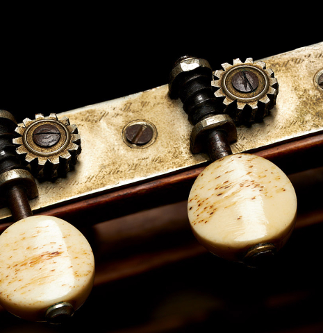 The tuning machines of a 1903 Enrique Garcia classical guitar made of spruce and mahogany