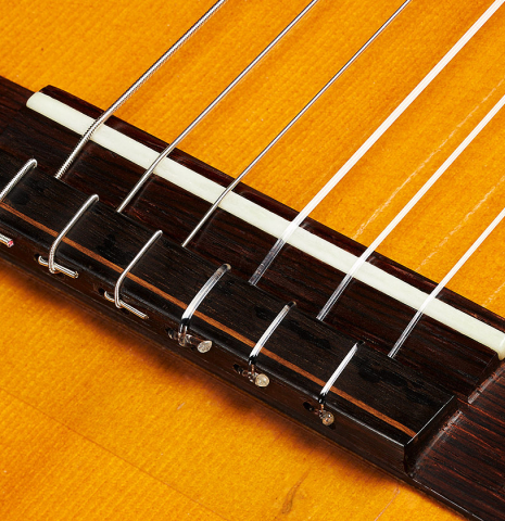 The bridge, tie-block and saddle of a 1993 Abel Garcia classical guitar made of spruce and CSA rosewood