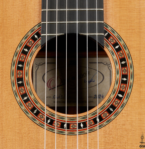 The rosette of a 2024 Dario Garcia classical guitar made of cedar and African rosewood